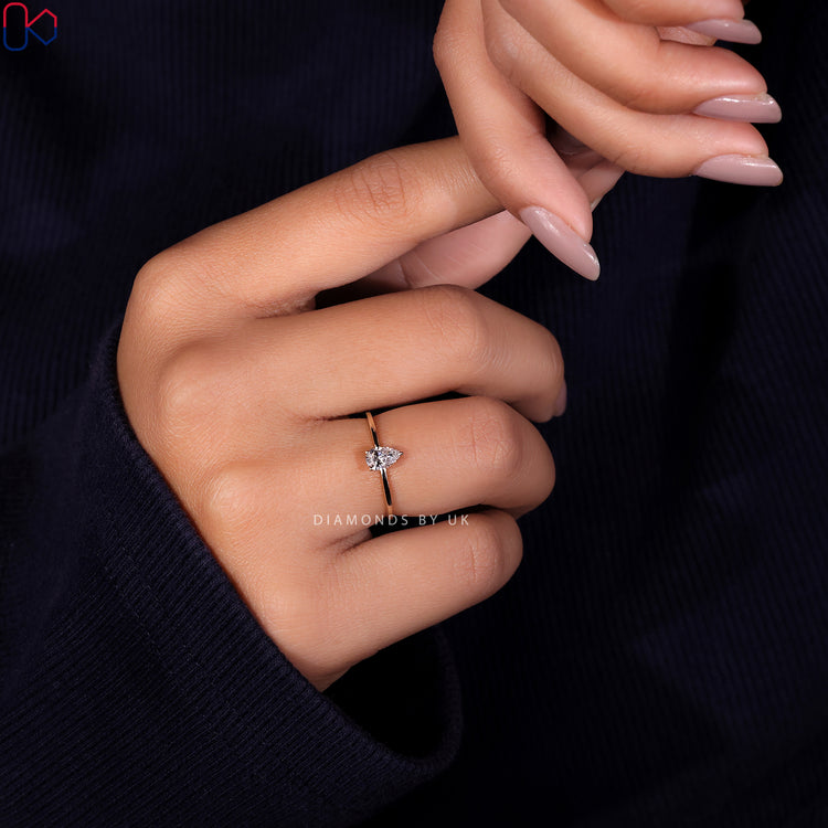 Handmade ring featuring a stunning pear cut diamond ring and prong setting ring.