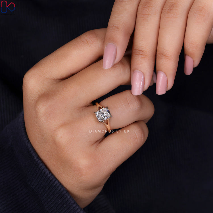 Yellow gold engagement ring featuring an elongated cushion cut diamond.
