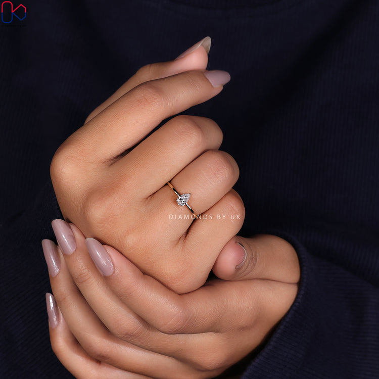 Shop to buy engagement ring featuring a radiant pear cut diamond ring in yellow gold diamond ring.