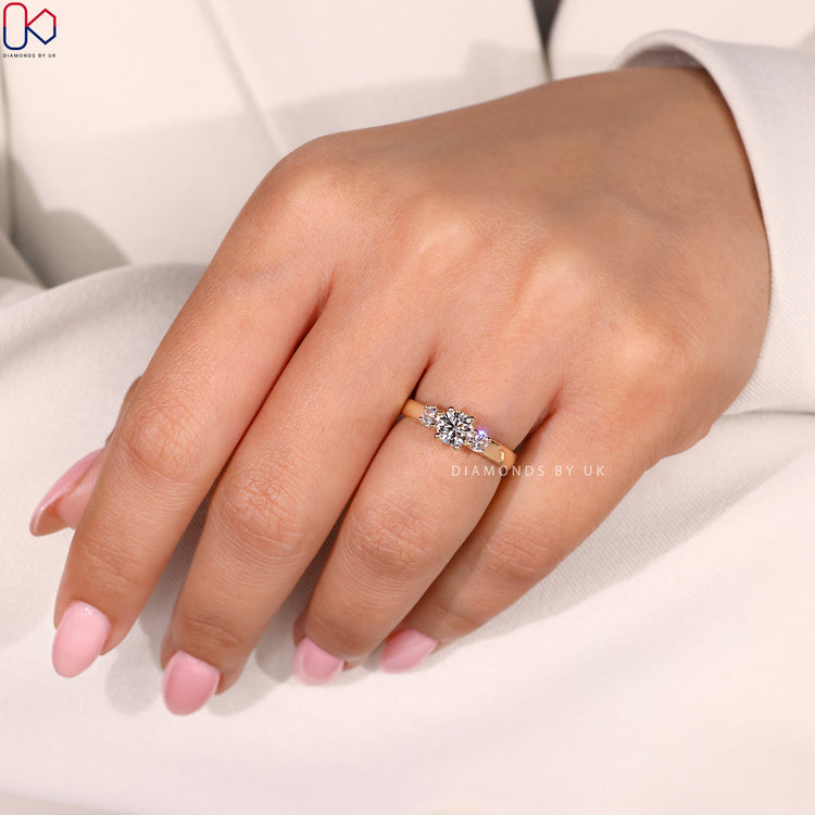 Lab Grown Diamond set in a handmade ring with three round diamonds in a prong setting.
