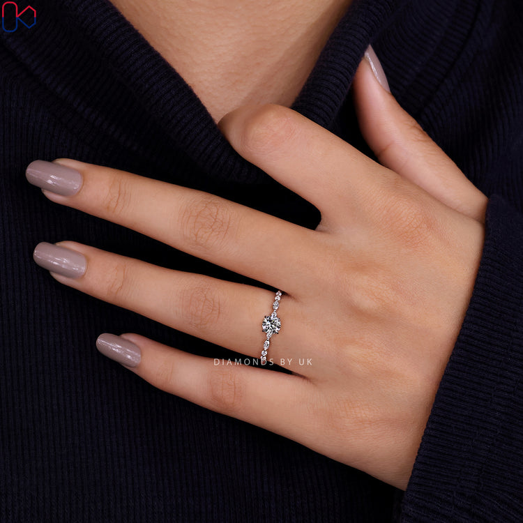 Diamondsbyuk engagement ring with a floating bubble band ring and a round cut diamond ring.
