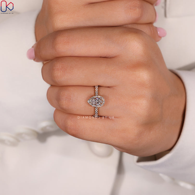 Pave diamond ring with a pear shaped centre stone, set in a classic yellow gold ring.
