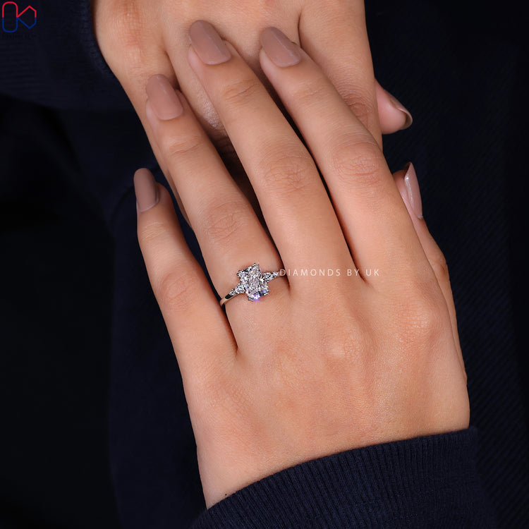 Round cut diamond in a radiant cut diamond ring with a double claw prong setting