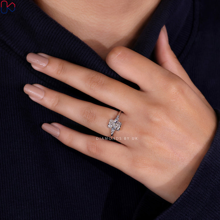 Round side stone engagement ring with radiant cut diamond and IGI certified stones.