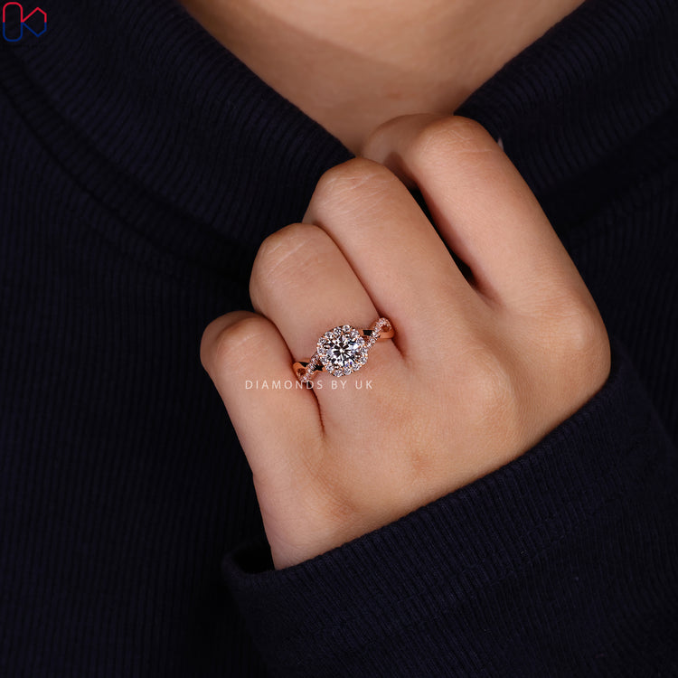 Halo diamond ring with round cut center stone.
