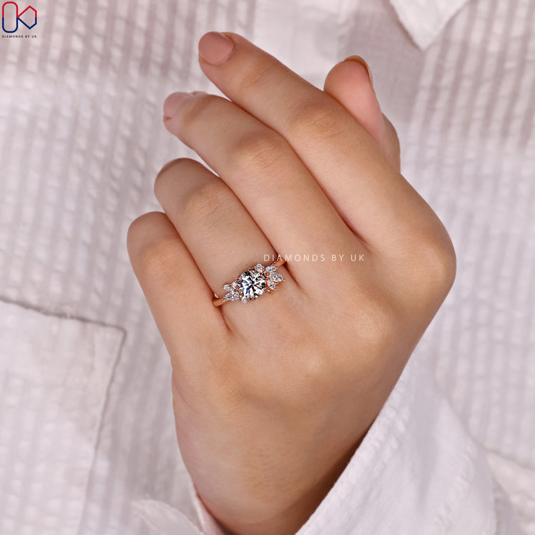 Rose gold engagement ring set with marquise side stones.
