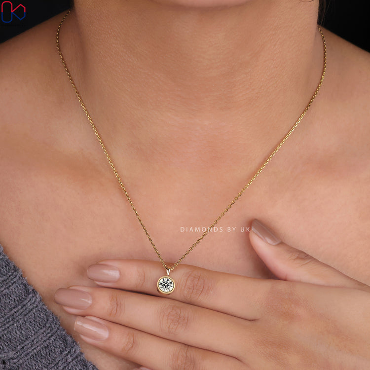 Handmade jewelry, featuring a round diamond pendant.
