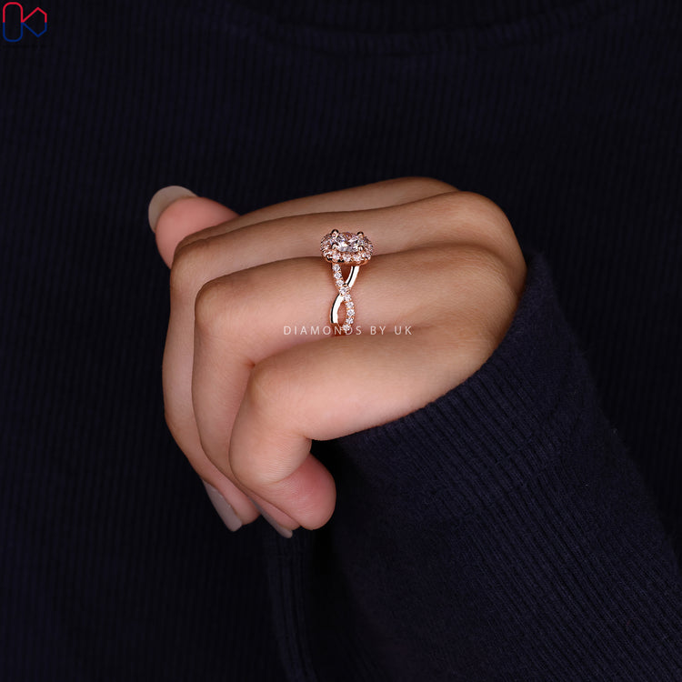 Custom twisted pave diamond ring with halo design.
