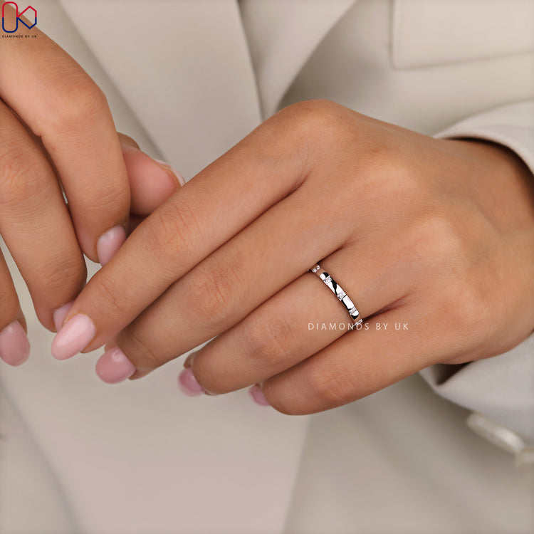 Custom wedding band with flush set round diamonds.
