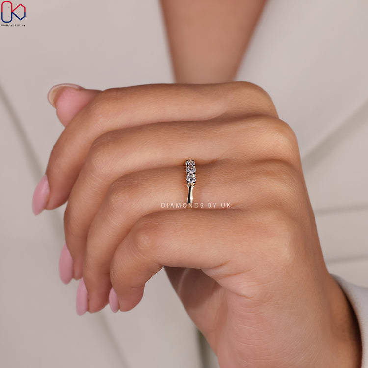 Lab Grown Diamond band in a yellow gold three stone style.
