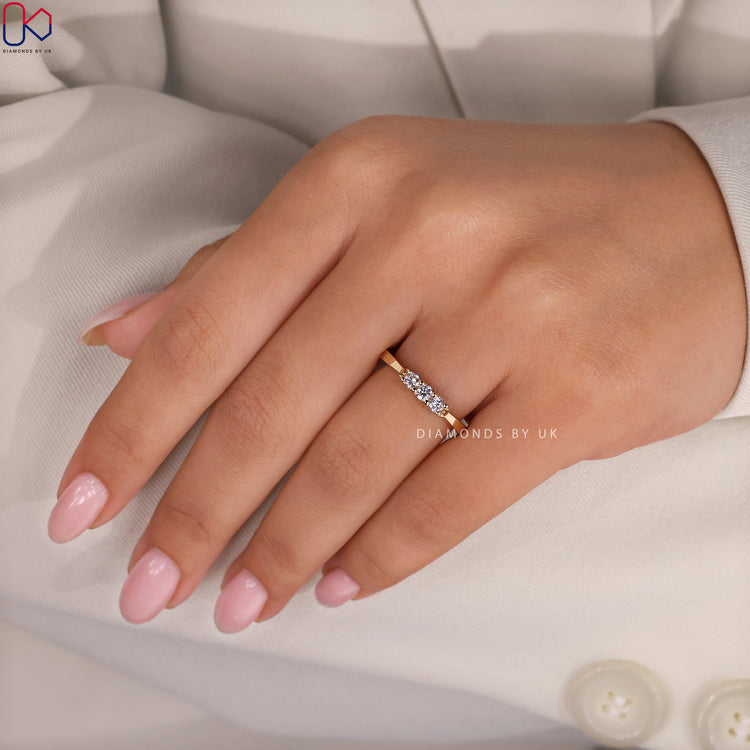 Tapered shank wedding band with round cut diamonds.
