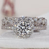 White Gold engagement ring with wedding band featuring a round cut diamond in a stunning halo setting.
