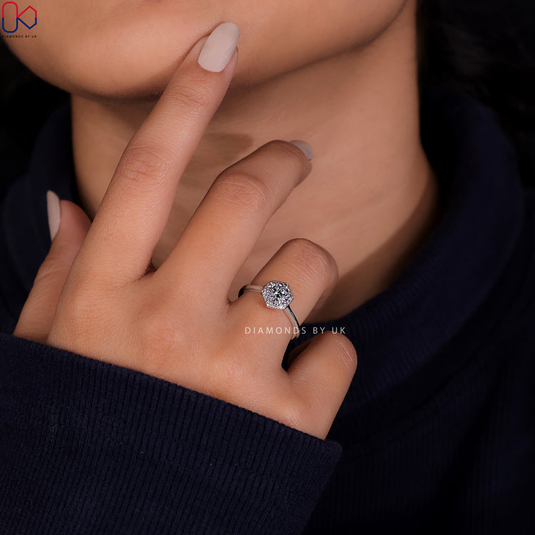 Elegant Diamondsbyuk engagement ring featuring a round cut diamond in a halo setting.
