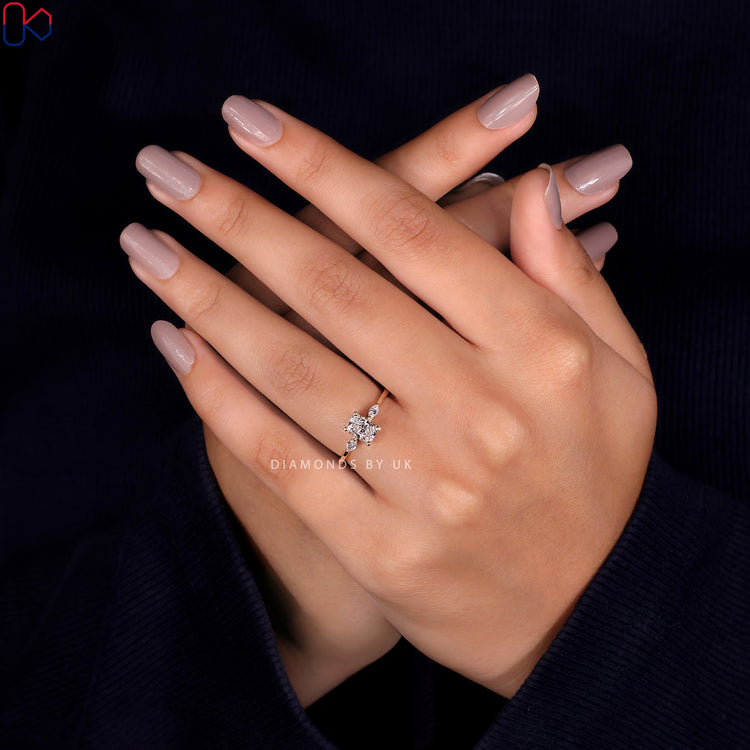 Yellow gold diamond ring featuring a 3 stone design with radiant and marquise cut stones.
