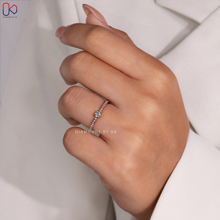 Diamondsbyuk ring showcasing a pave setting ring with a high-quality round diamond engagement ring.
