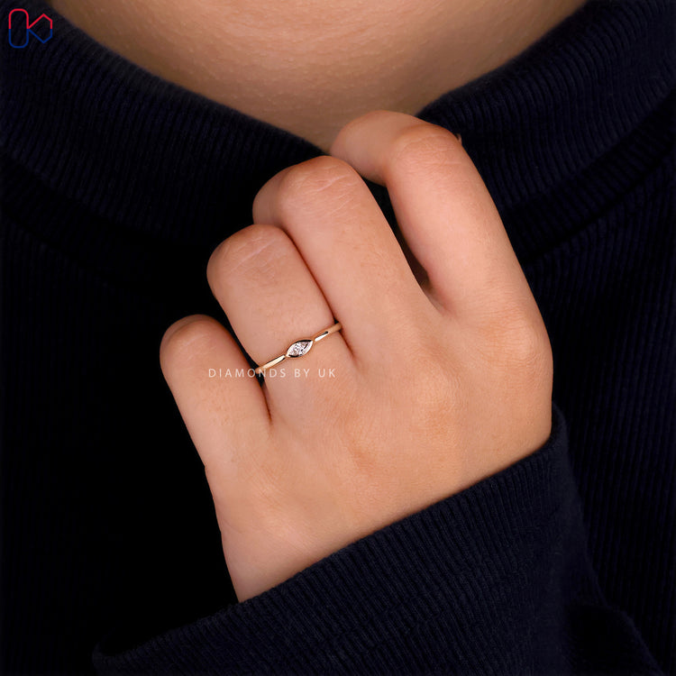 East-West style engagement ring in yellow gold
