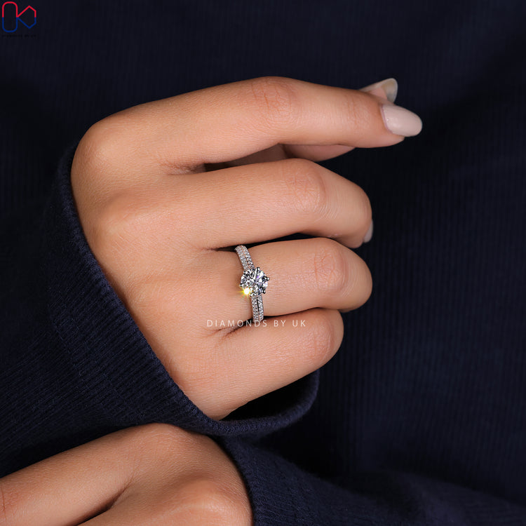 Two row pave ring with a brilliant round cut diamond ring centre.