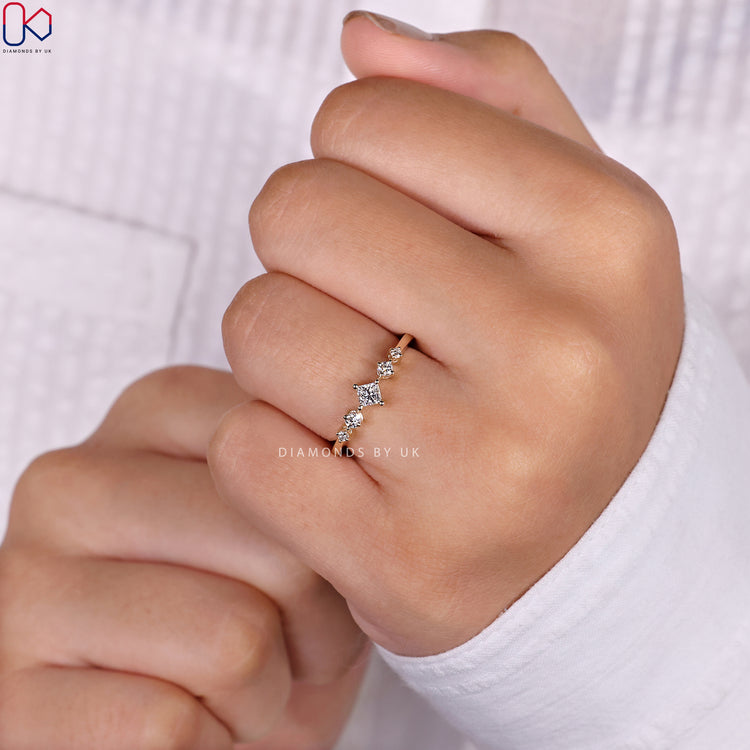 Round side stone engagement ring design.
