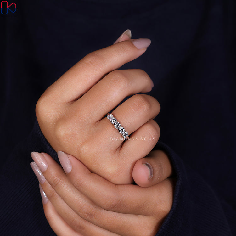 Minimalist wedding band featuring a sleek design and Lab Grown Diamond accents.
