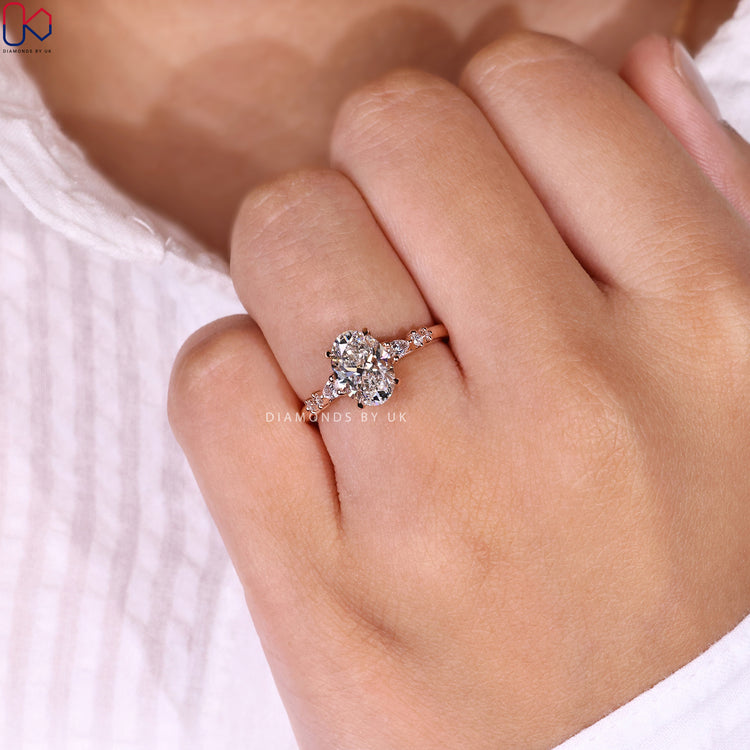 Customize ring with oval diamond and rose gold finish.
