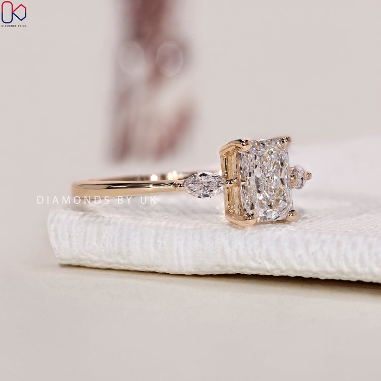 Marquise cut ring centre stone with radiant cut side stones in a Diamondsbyuk ring.
