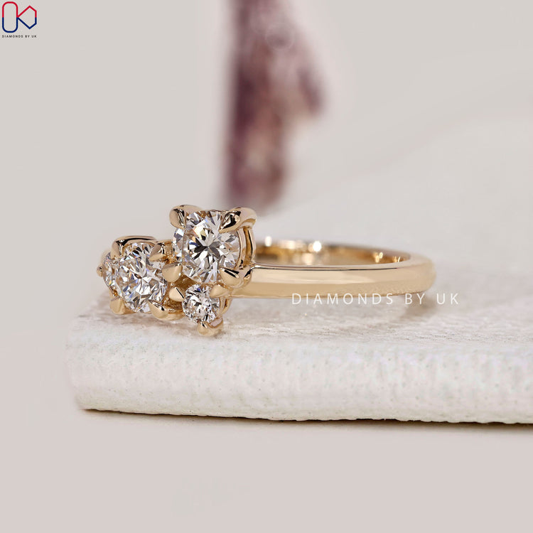 4 round cut diamond ring in yellow gold.
