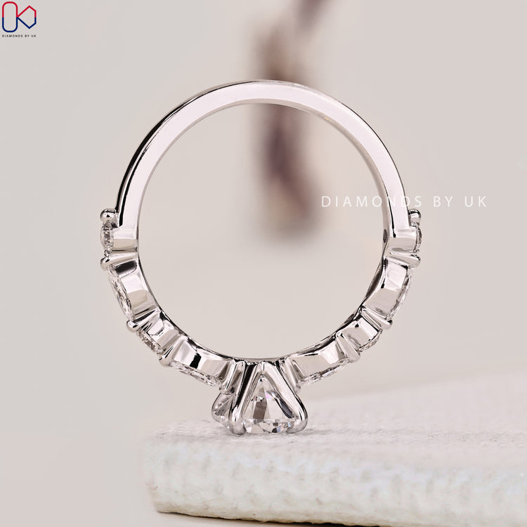 Buy engagement ring with marquise and round side stones.
