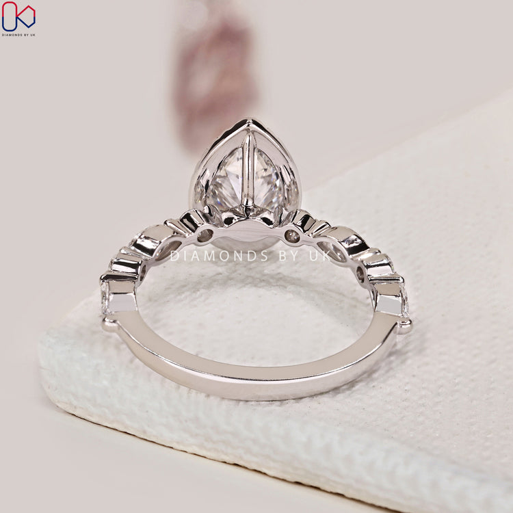 White gold engagement ring with pear shaped diamond.
