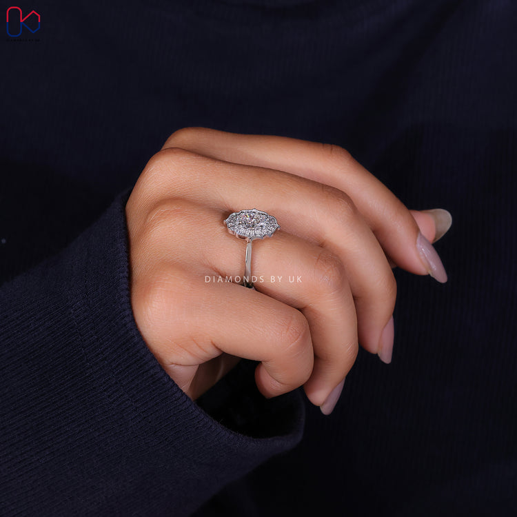 White gold ring featuring an elegant oval halo engagement ring.
