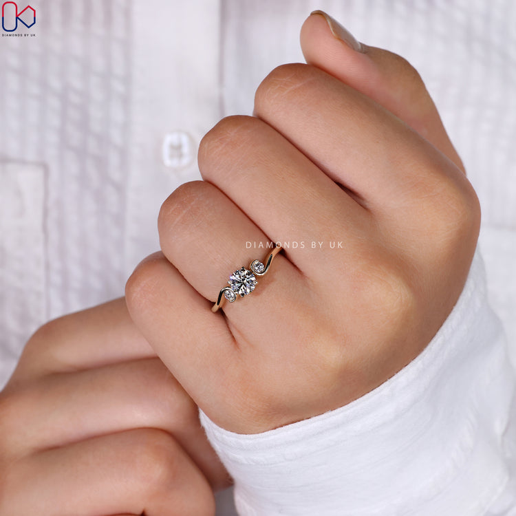 Yellow gold engagement ring with a brilliant center stone.
