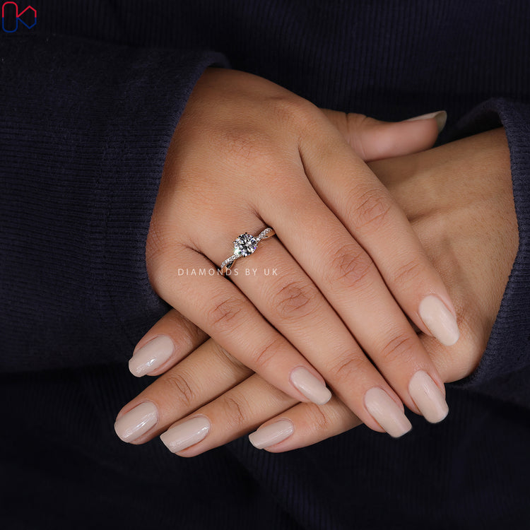 Round cut side stone in handmade jewellery.
