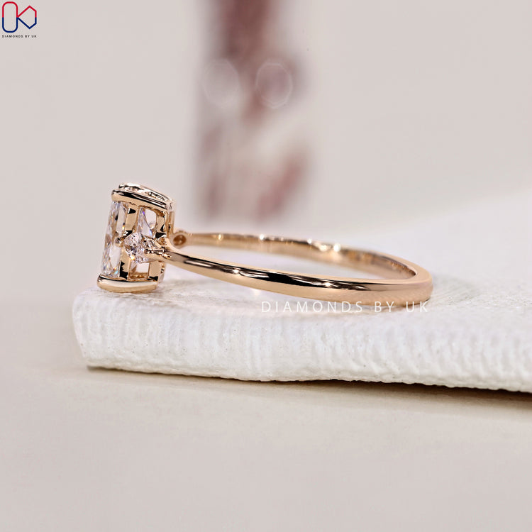 Prong setting ring with radiant cut diamond and marquise cut side stones in a 3 stone ring.
