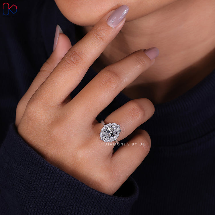 Handmade jewellery featuring an oval halo engagement ring design.
