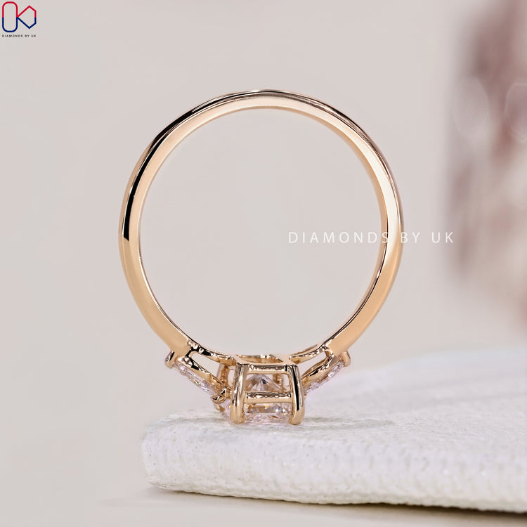 IGI certified Diamondsbyuk engagement ring featuring radiant and marquise cuts in a 3 stone setting.
