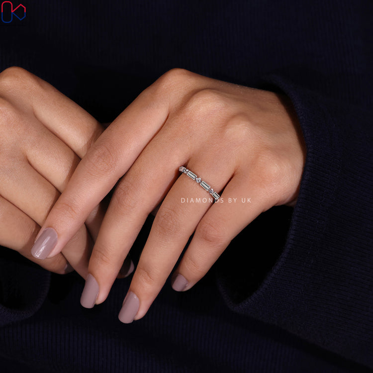 Round and baguette diamond wedding band with a sophisticated and unique design.
