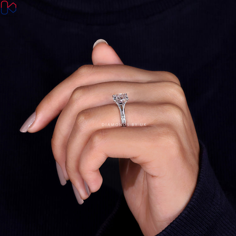 Round cut diamond set in a beautiful blue diamond ring.