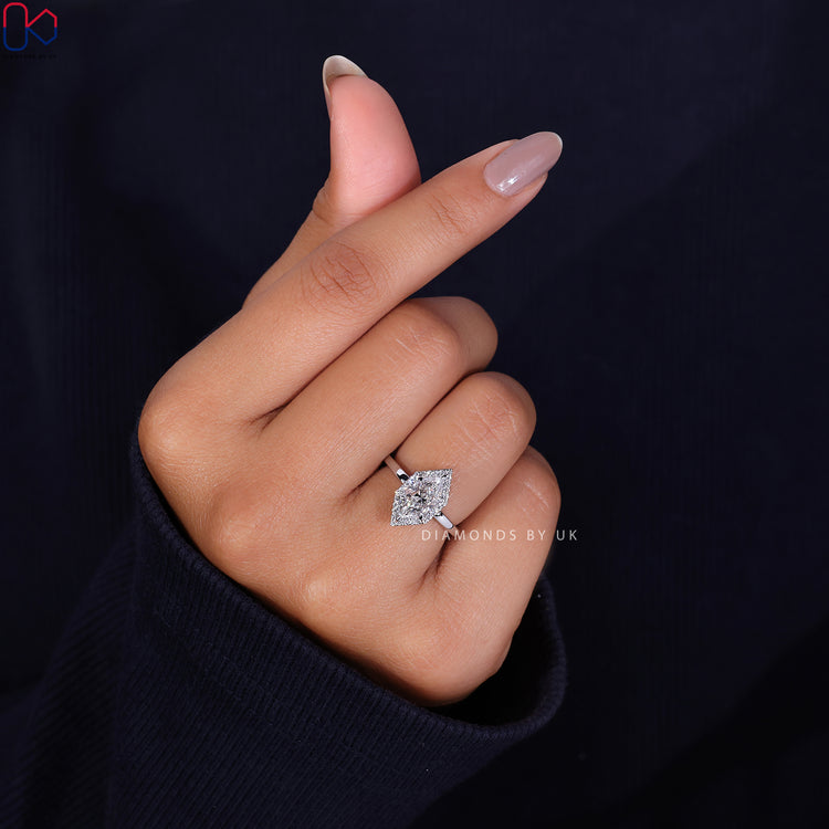 Diamondsbyuk engagement ring featuring a white gold ring and halo diamond.