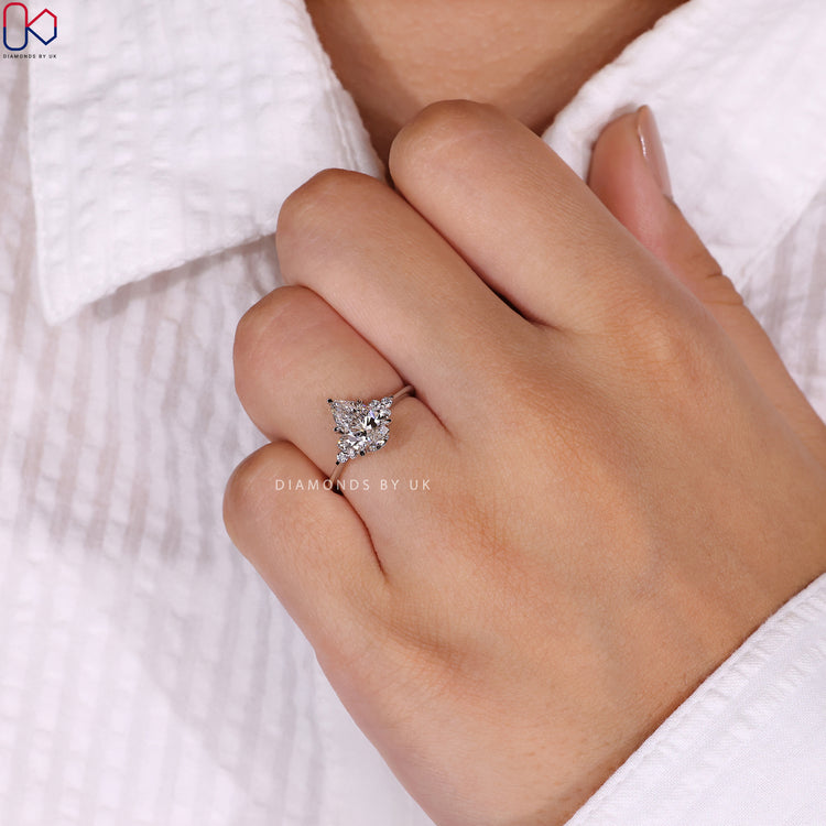 Buy engagement ring with round side stones.
