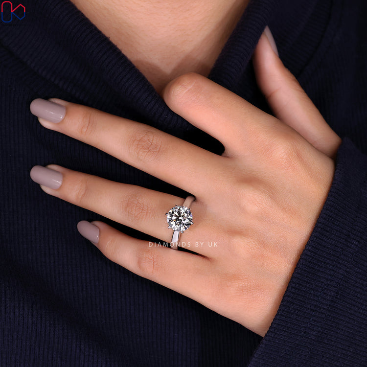 Handmade jewellery featuring a round diamond engagement ring with a solitaire setting.