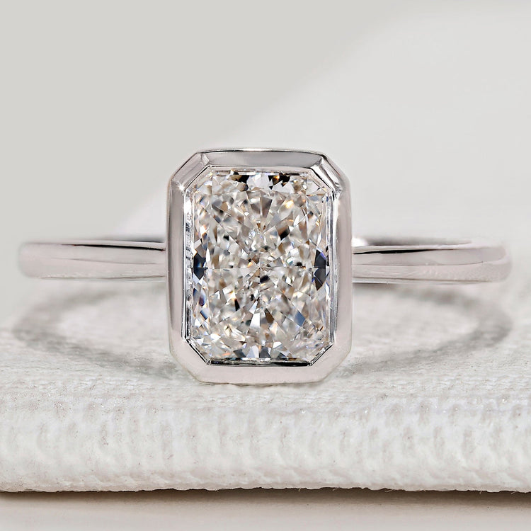 Radiant cut solitaire ring with bezel setting.