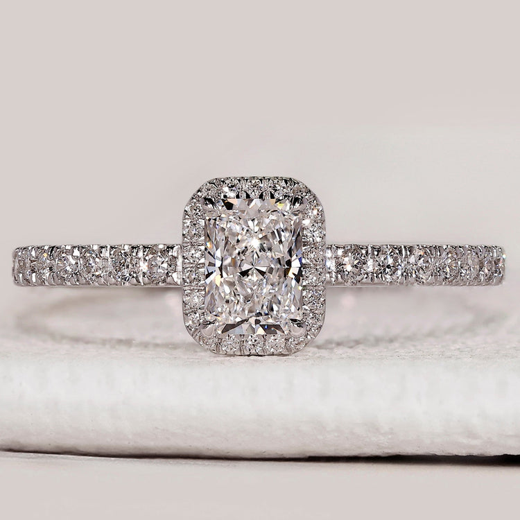 Radiant cut ring with halo and pavé diamond style.