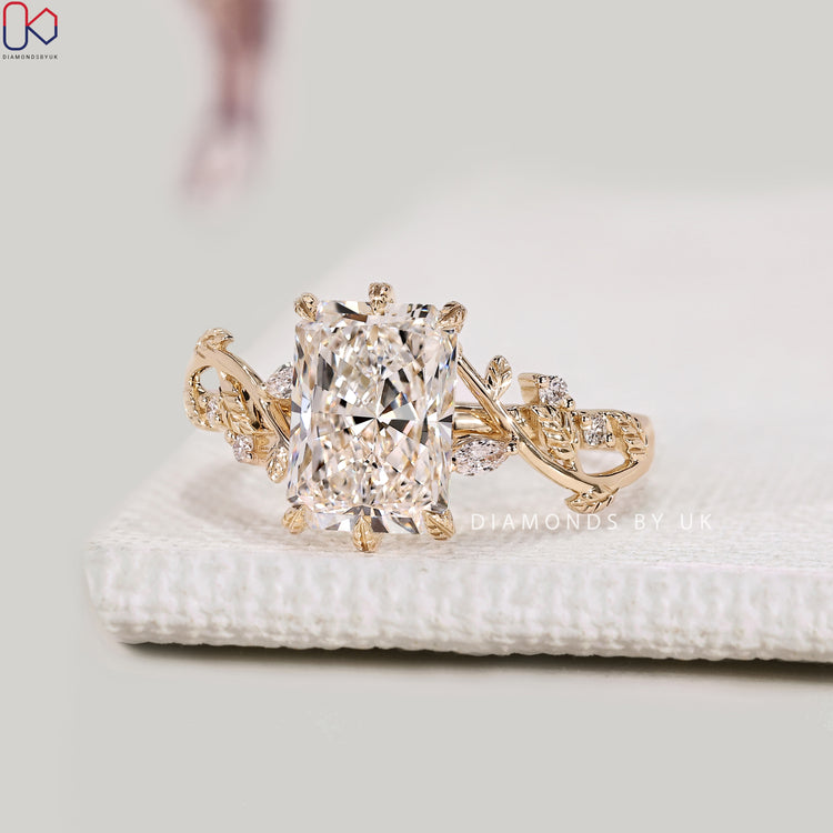 Radiant diamond ring with nature inspired leaf prongs.