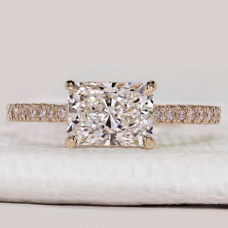Radiant cut ring with east to west hidden halo style.