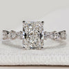 Radiant cut ring with marquise and round pavé diamonds.
