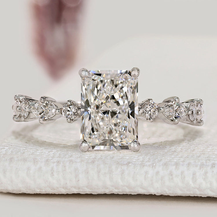 Radiant cut engagement ring with marquise side stones.
