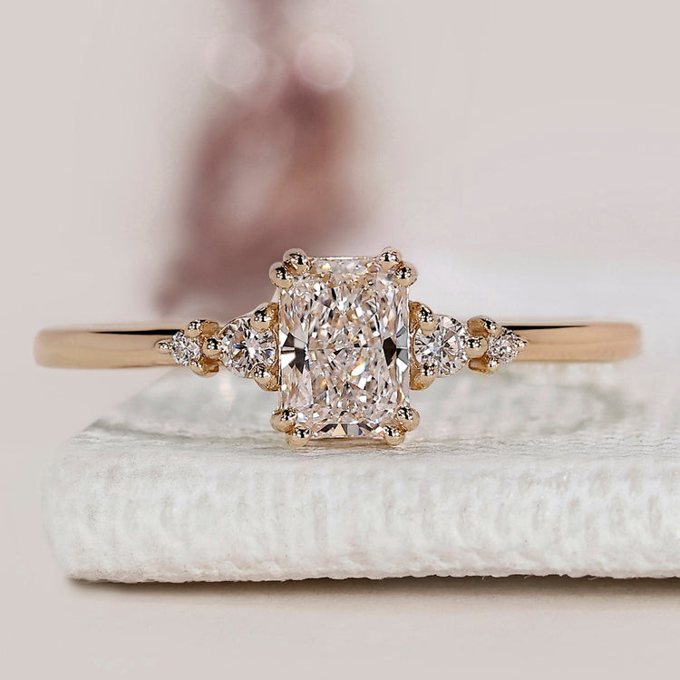 Radiant cut ring with round side stones design.