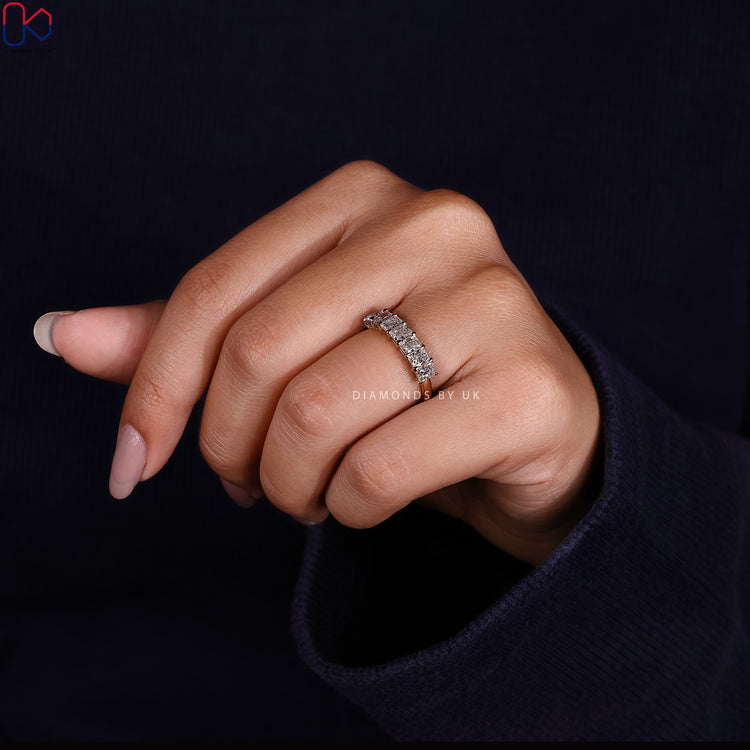 Yellow gold wedding band featuring a simple seven diamond half eternity structure.
