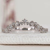Round cut diamond band with curved style and prong setting.