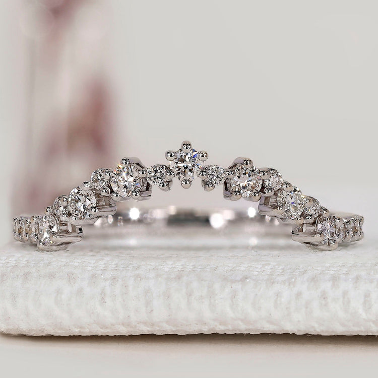 Round cut diamond band with curved style and prong setting.