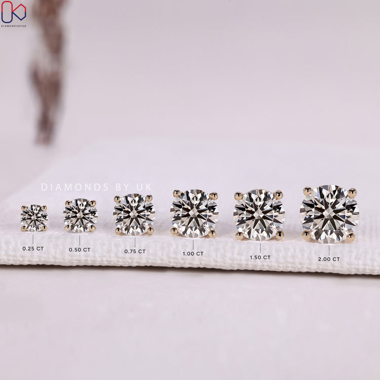 Round cut diamond stud earrings with four prong setting.  